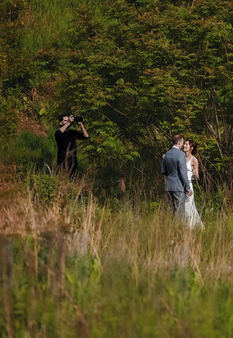 Nem behind the scenes photographing bride and groom in Los Angeles Park