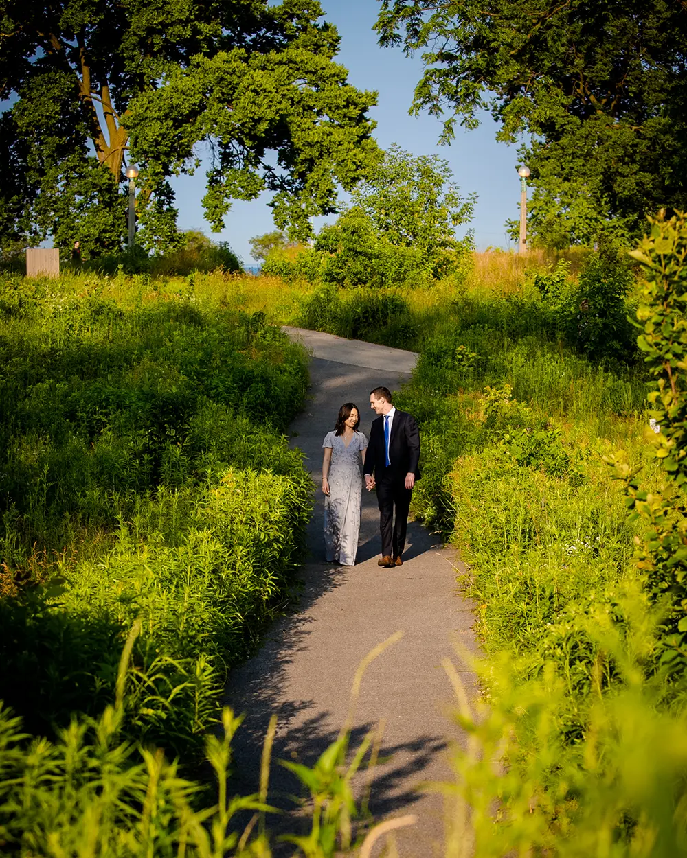 Couple holding each other for hand and walking in the park. Engagement Photos in Los Angeles