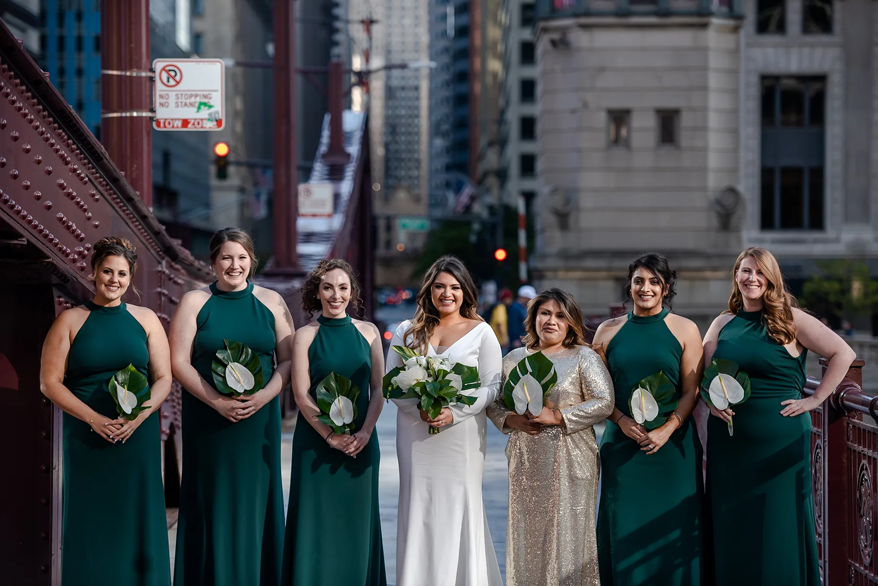 Bridesmaids posing with bride and bouquet of flowers