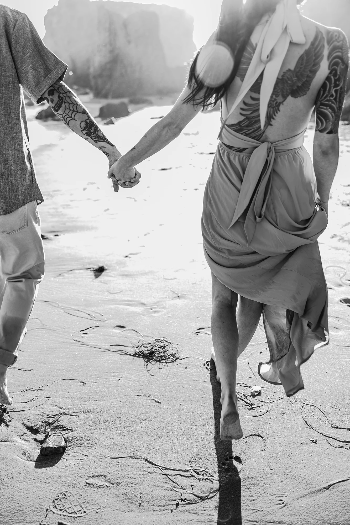 El Matador beach couple walking and holding for hands black and white photo