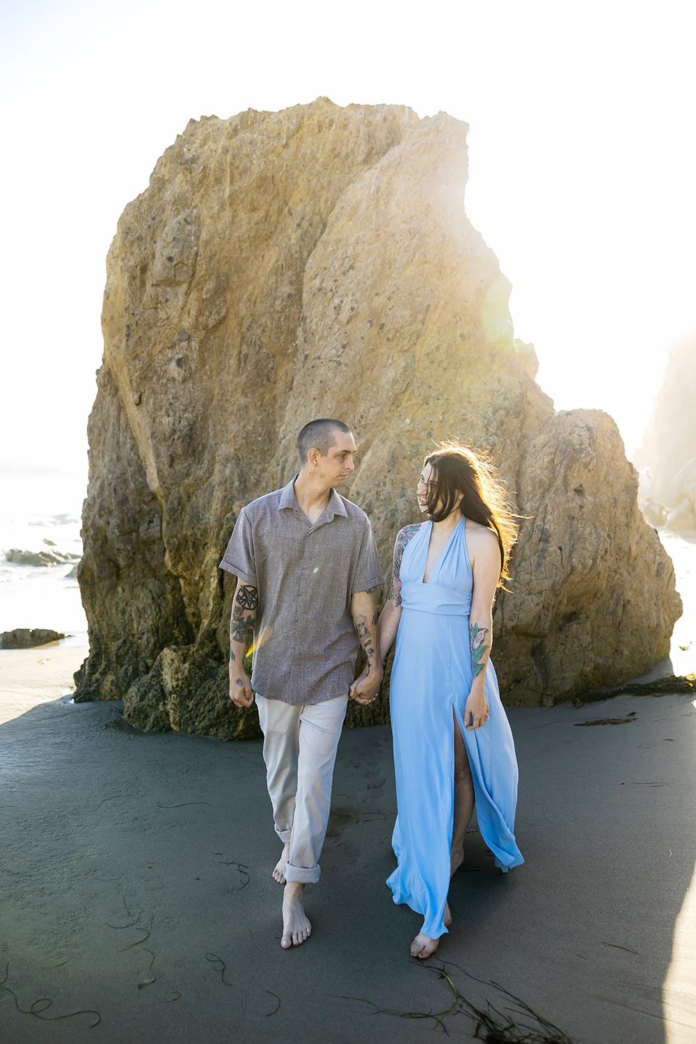 Couple walking at the El Matador Beach and posing for engagement photo session, NZ WEDDING STUDIO