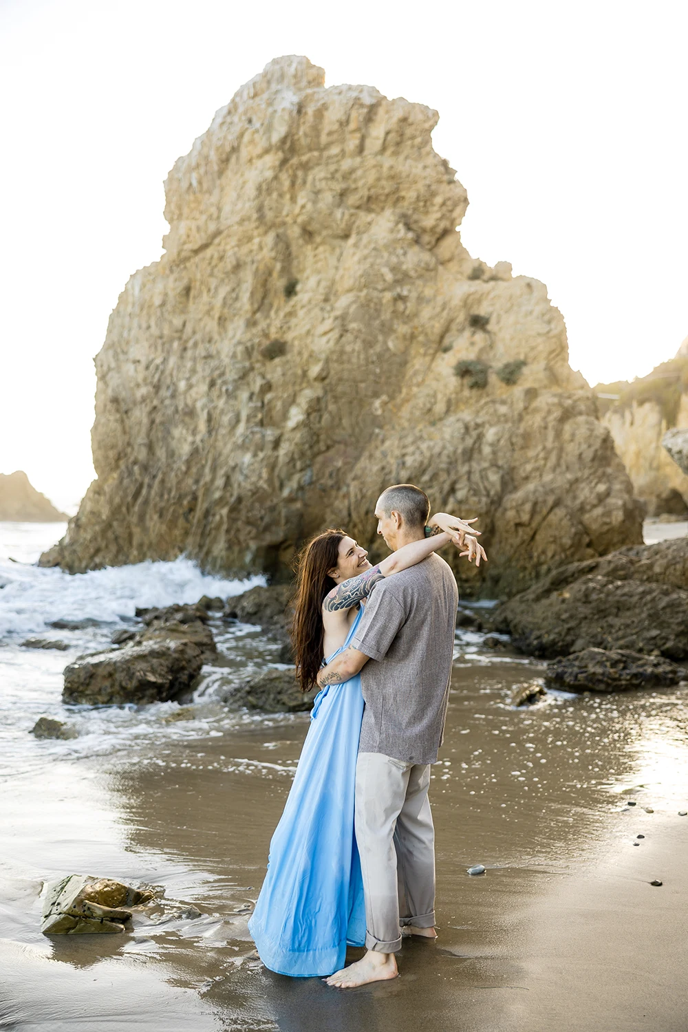 El Matador Beach couple hugging in a front of the sharp rocks NZ WEDDING STUDIO