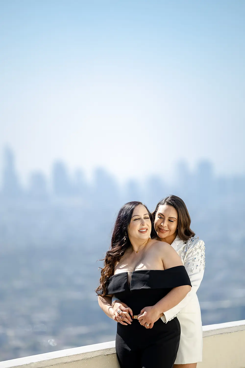LGBT Engagement photo session at Griffith Park Observatory with cityscape at the background